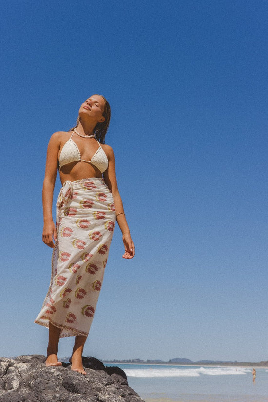 Ria Sarong Strawberry Cream — outdoor lifestyle portrait, full length model in natural setting, flowing strawberry cream sarong wrap, hand block print cotton, Jaipur artisan | Daughters of India